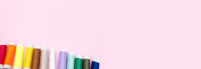 Banner. Colored sewing thread on a pink background
