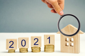 2021 wooden blocks and miniature house. Real estate concept. Family budget planning. Investments,...