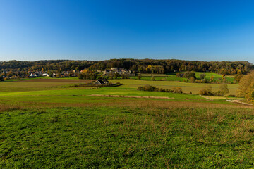 Obraz premium Beautiful view over the Jekervallei (english Jekervalley) in Maastricht with the local vineyards turning to the warm autumn colours giving a very idyllic feeling full of nostalgia.