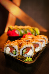 Traditional Japanese rolls on a festive table against a background of garlands