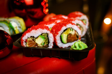 Traditional Japanese rolls on a festive table against a background of garlands