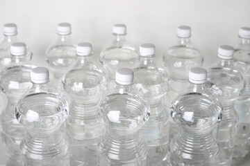 Transparent plastic water bottles on white background
