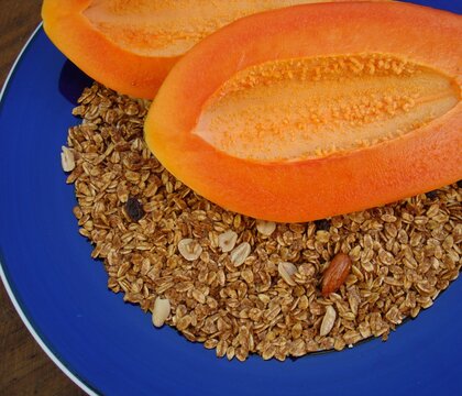 Papaya partida a la mitad con granola  y frutos secos