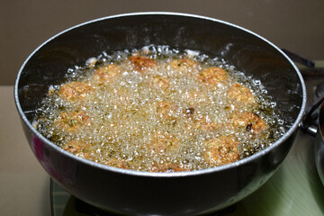 cooking homemade INDIAN CHINESE DRY and crispy MANCHURIAN BALLS frying manchurian balls in oil vessel