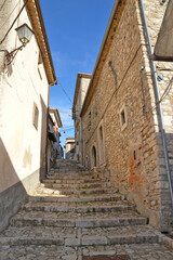 Fototapeta na wymiar A narrow street among the old houses of di Pietrelcina, a medieval village in the Campania region, Italy.