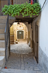 A narrow street among the old houses of di Pietrelcina, a medieval village in the Campania region, Italy.