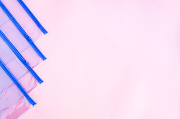 Transparent plastic zipper bags on soft light background