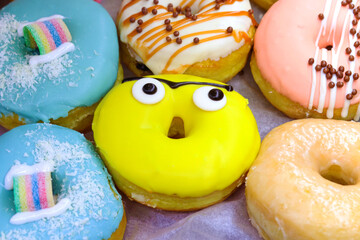 Glazed donuts close up. Donut with funny eyes. Unhealthy food concept