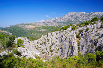 Fototapeta na wymiar Dalmatian coastline mountains near Omis. Sunny day with blue sky