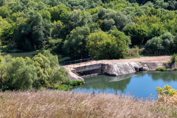 Fototapeta na wymiar Dam on the Vorgol river in the former estate of merchant Taldykin near the city of Yelets, Lipetsk region, Russia