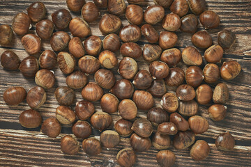 Top view of chestnuts on brown wooden background.