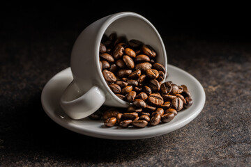 Roasted coffee beans in cup.