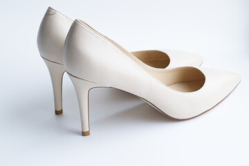 a pair of leather shoes, beige pumps, on a light background, with a place for text, inscriptions. Fashionable, stylish, women's shoes. Beautiful shoes, preparation for the holiday, sale