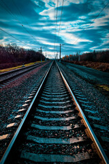 Fototapeta premium railway, rails and sleepers without trains close-up, on a beautiful sunset overcast sky