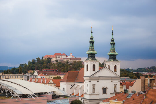 Generic view of the city with the Spilberk castle and the Catholic church of St. Michael. In the background is the Spielberg Castle on a high green hill.