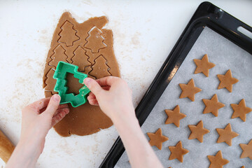 Making christmas gingerbread cookies. Cutting Christmas ginger cookies top view