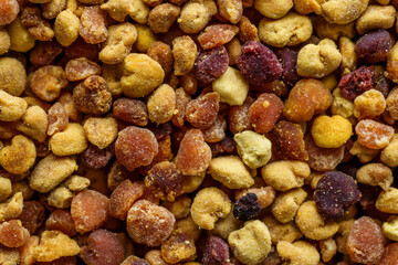 Macro shot of bee pollen or perga.Raw brown, yellow, orange and blue flower pollen grains or bee bread packed by worker honeybees. Healthy food supplement