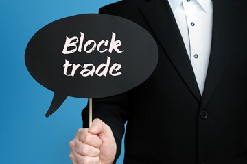 Block trade. Businessman holds speech bubble in his hand. Handwritten Word/Text on sign.
