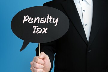 Penalty Tax. Businessman holds speech bubble in his hand. Handwritten Word/Text on sign.