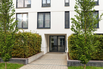 Fototapeta na wymiar View to entrance door of a modern residential building with new apartments in the city