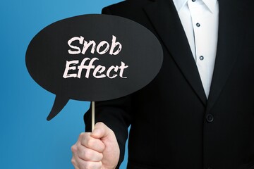 Snob Effect. Businessman holds speech bubble in his hand. Handwritten Word/Text on sign.