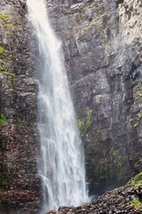 Obraz premium Waterfall falling from high rocks in Fulufjallet Nature Reserve