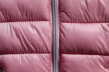 Closeup shot of the pink down winter jacket