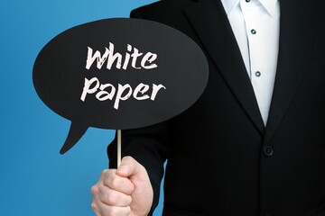 White Paper. Businessman holds speech bubble in his hand. Handwritten Word/Text on sign.