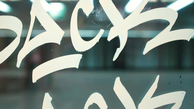 Drawn stripes on the glass of the subway door. Damage to public property by street hooligans. The door opens at the station.