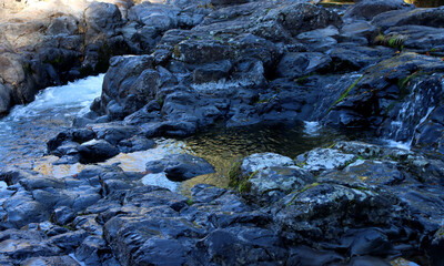 Rocks and small stream above the falls