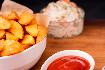 Tradition french fries from organic bio potato wedges with skin dip in ketchup