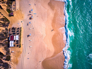 People on a ocean beach sunset aerial view
