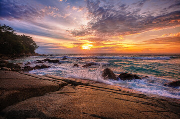 Beautiful sunset on the rock beach.