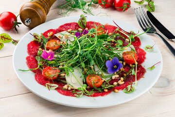 beef carpaccio with vegetables and micro-green pea sprouts