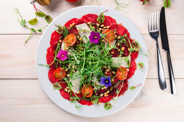 beef carpaccio with vegetables and micro-green pea sprouts