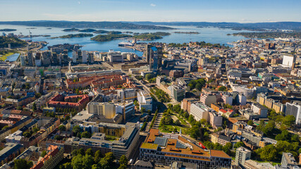 Oslo, Norway. Beautiful panoramic aerial view photo from flying drone for Oslo city center. Against the background of the sea, mountains and blue sky on a sunny summer day. (Series) © Sandis