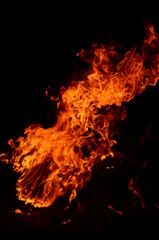 Obraz na płótnie Canvas Photo of burning orange and yellow fire with black background