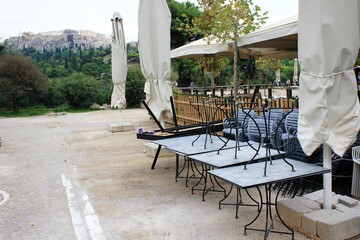 Greece, Athens, November 3 2020 - Chairs, tables and other furniture stacked outside closed cafe-restaurant around Acropolis hill, after the announcement for Covid-19 lockdown.