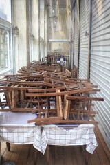 Greece, Athens, November 3 2020 - Chairs, tables and other furniture stacked outside closed cafe-restaurant around Acropolis hill, after the announcement for Covid-19 lockdown.