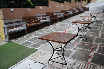 Greece, Athens, November 3 2020 - Chairs, tables and other furniture stacked outside closed cafe-restaurant around Acropolis hill, after the announcement for Covid-19 lockdown.