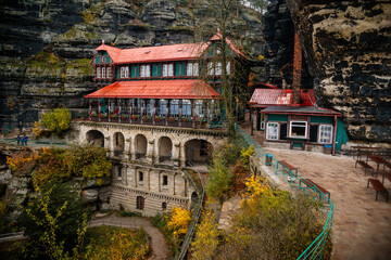 Obraz premium Panorama of holiday chateau, castle Falcon's Nest (Sokoli Hnizdo) near Prebischtor Gate (Pravcicka brana) in Bohemian Switzerland national park in autumn, Hrensko, Czech Republic