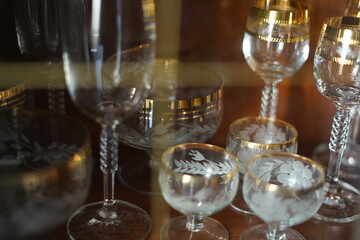 Glass holiday tableware in a mahogany Cabinet.