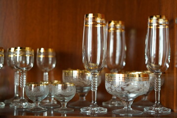Glass holiday tableware in a mahogany Cabinet.
