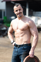 Fit Man Holding Weights Outdoors