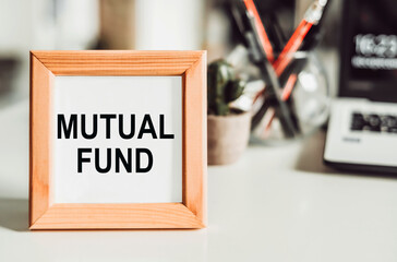 Wooden frame with office background with the text "mutual fund".