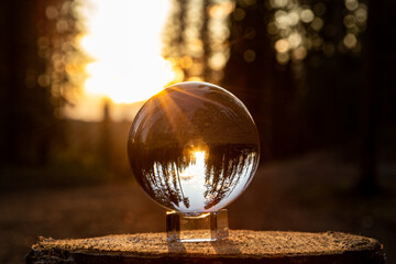 Juggling ball reflecting the sunlight in the forest. Concept about lifestyle, travel and leisure. 