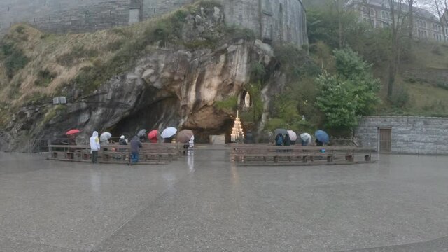 SLOW MOTION - The Grotto of Massabielle is the place where the Virgin appeared to Bernadette Soubirous, a 14-year-old girl, from Lourdes, France, in 1858. At the back left of the Grotto is the Spring.