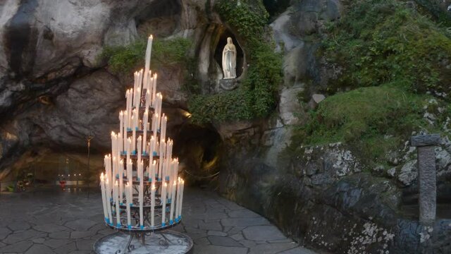 SLOW MOTION - The Grotto of Massabielle is the place where the Virgin appeared to Bernadette Soubirous, a 14-year-old girl, from Lourdes, France, in 1858. At the back left of the Grotto is the Spring.