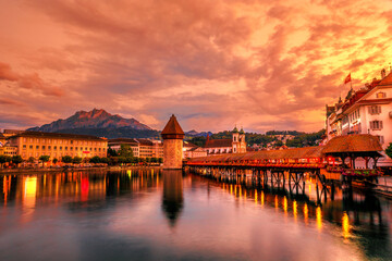 Mount Pilatus mountain overlooking the skyline of Lucerne town of Switzerland. Dusk cityscape with...