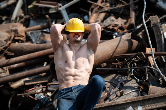 Man With Six Pack in Old Scrap Metal Garage